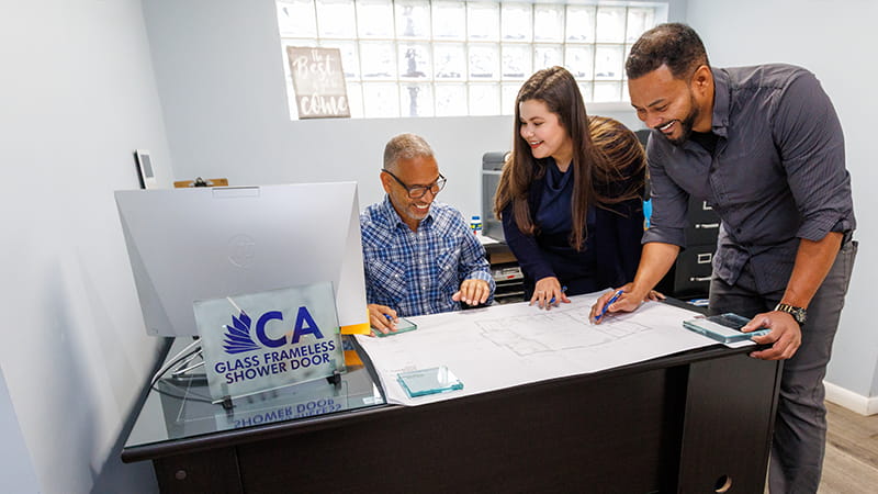 CA Glass team assisting a customer with frameless shower door and custom glass options in our New Jersey showroom
