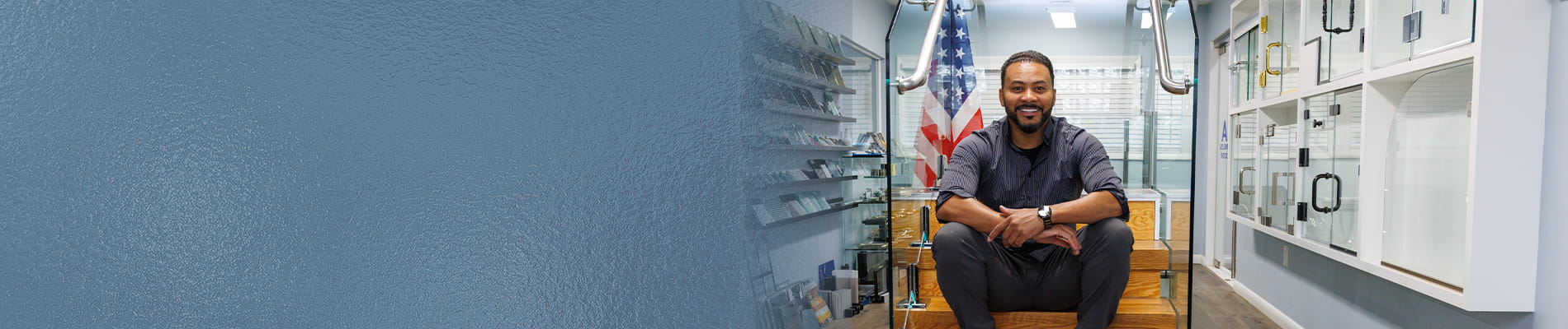 Owner of CA Glass showcasing completed glass railing installation project in New Jersey