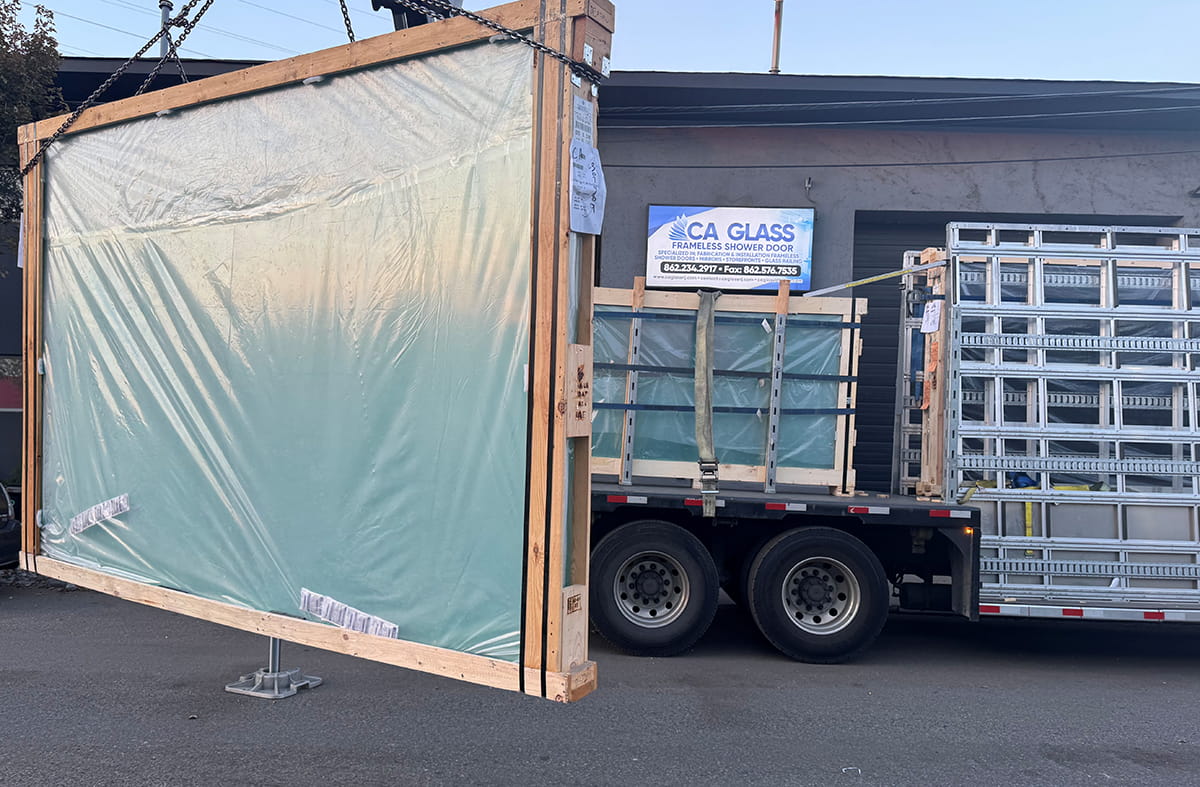 Professional CA Glass shower door installer completing frameless glass door installation in New Jersey home